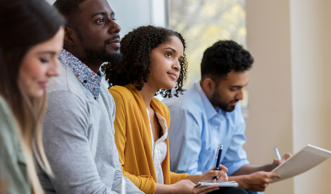 people listening and taking notes
