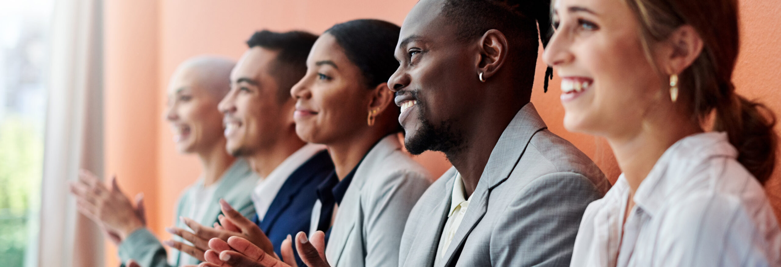 smiling line of people clapping